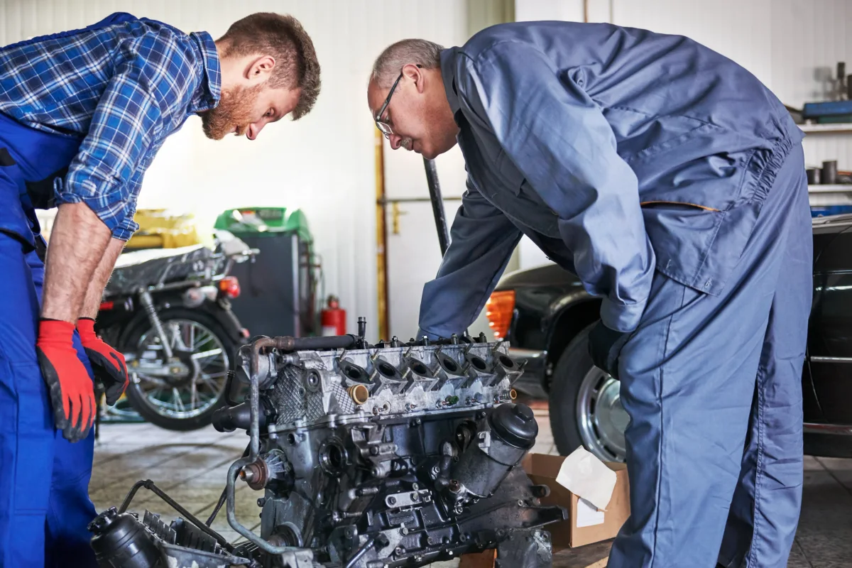 Mechanics repairing car in workshop